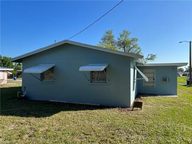 View of side of home with a yard