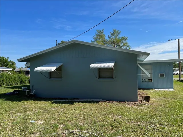 View of home's exterior with a yard