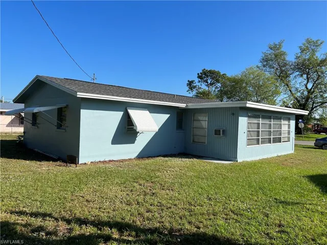 Back of property with a yard