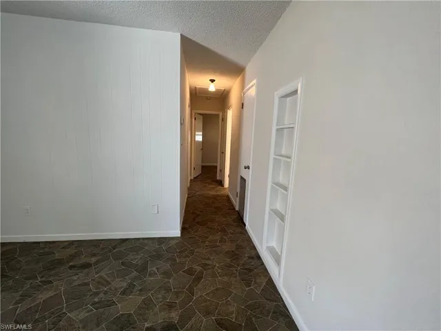 Hallway with built in decorative shelf