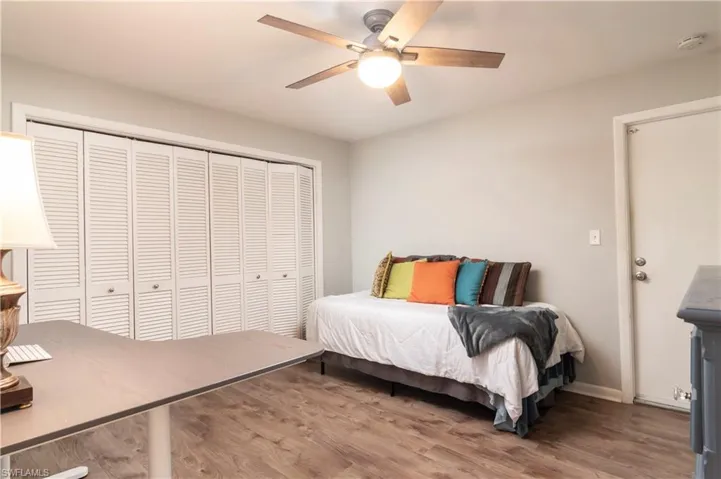 Bedroom featuring ceiling fan, a closet, and hardwood / wood-style flooring