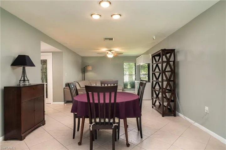 Tiled dining room with ceiling fan