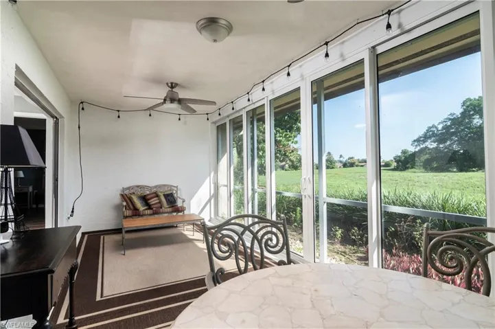 Sunroom / solarium featuring ceiling fan