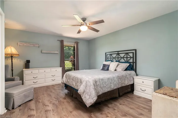 Bedroom featuring wood-type flooring and ceiling fan