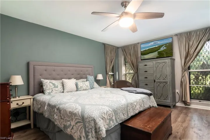 Bedroom with ceiling fan and dark hardwood / wood-style flooring