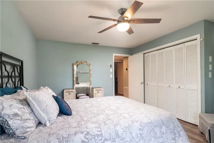 Bedroom with ceiling fan, a closet, and hardwood / wood-style flooring
