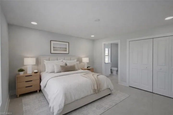 Bedroom with ensuite bath, recessed lighting, and a closet