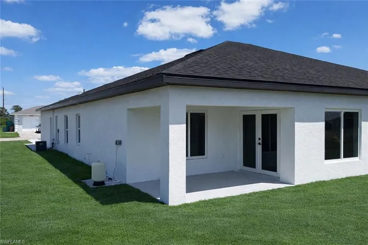 4531_Back of house featuring a yard, stucco siding, a shingled roof, and a patio