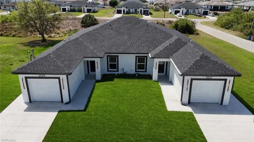 4531_Single story home with roof with shingles, a front lawn, and a garage
