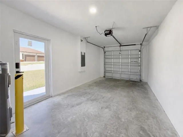 4531_Garage featuring electric water heater, a garage door opener, and electric panel