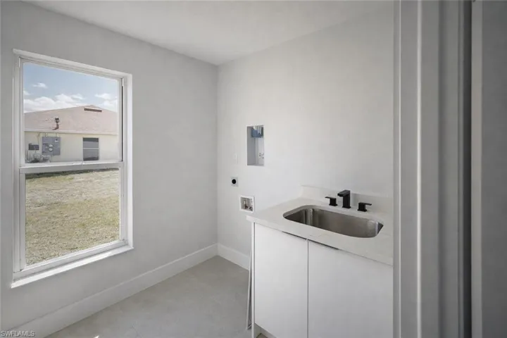 4529_Laundry room with cabinet space, washer hookup, hookup for an electric dryer, and light tile patterned floors