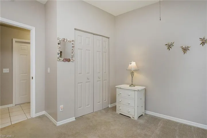 2nd bedroom with a closet and light colored carpet