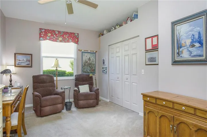 Den / Flex space featuring ceiling fan and light carpet