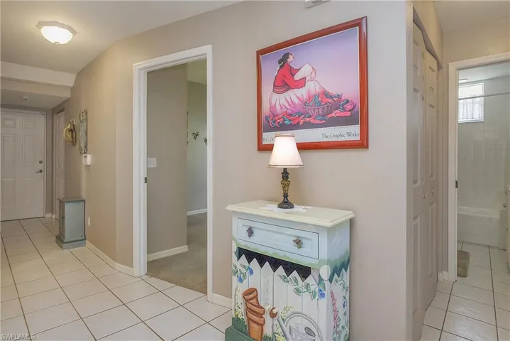 Hallway with light tile patterned flooring