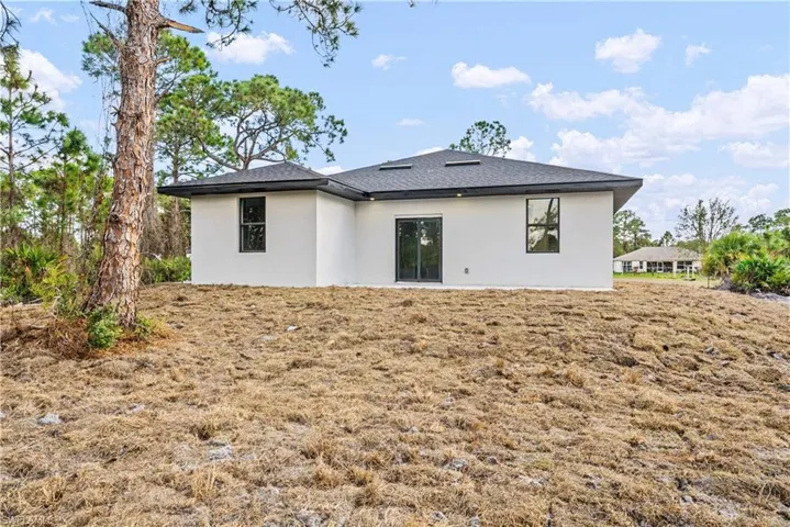 Back of property featuring stucco siding and a patio