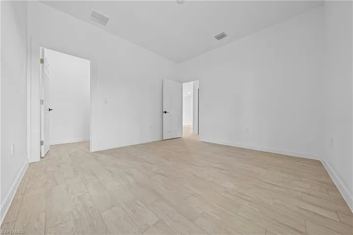 Empty room with light wood-style flooring