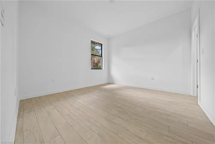 Spare room with light wood-style floors and baseboards