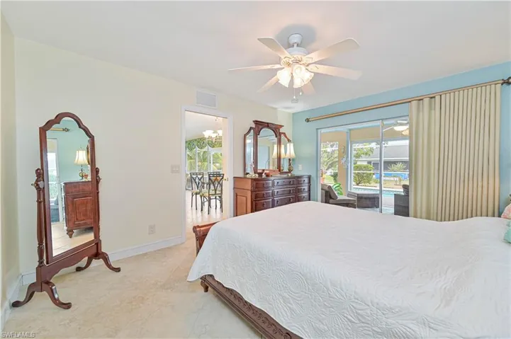 Primary bedroom with ceiling fan, access to exterior, and sliding glass doors