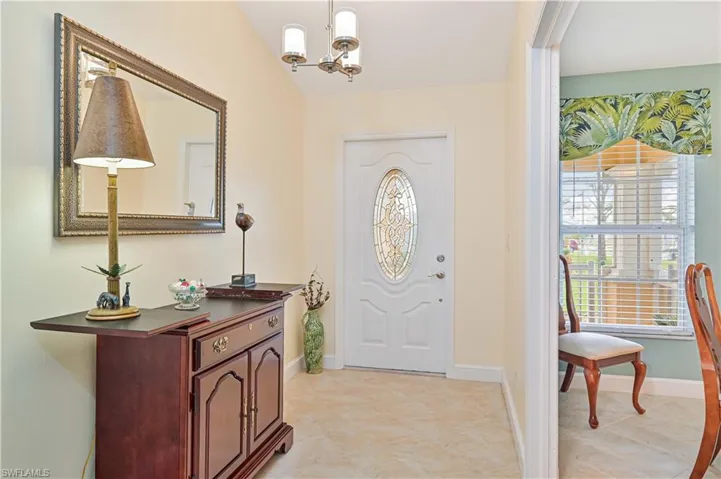 Foyer featuring an inviting chandelier and lofted ceiling