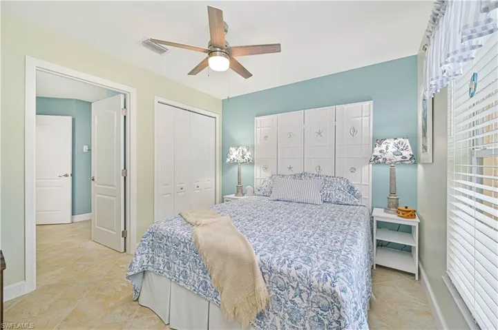 Guest bedroom featuring ceiling fan and a closet