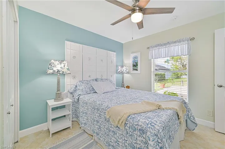 Guest bedroom featuring ceiling fan and a closet