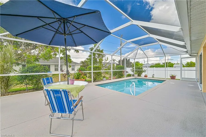 View of pool with a patio and a lanai
