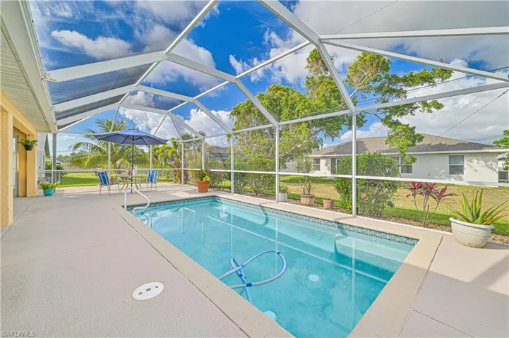 View of pool featuring enclosure and a patio area