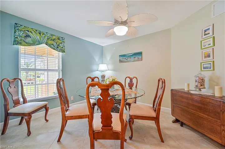 Tiled dining room with ceiling fan