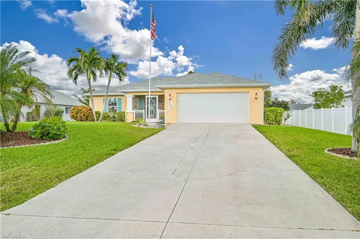 View of front of house featuring a garage and a front lawn