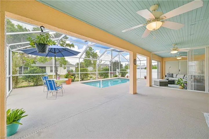 View of pool with a patio and a lanai