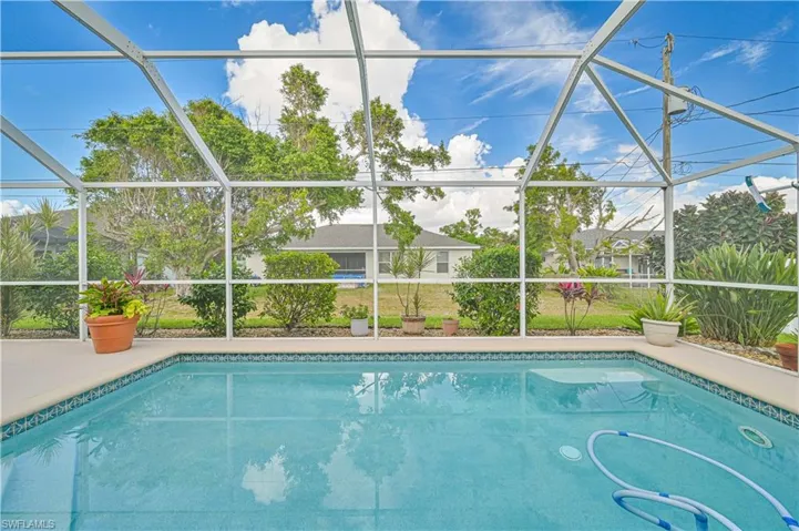 View of swimming pool with a lanai