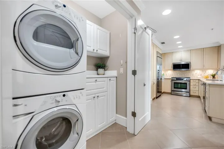 Laundry area with built-in cabinets for storage space