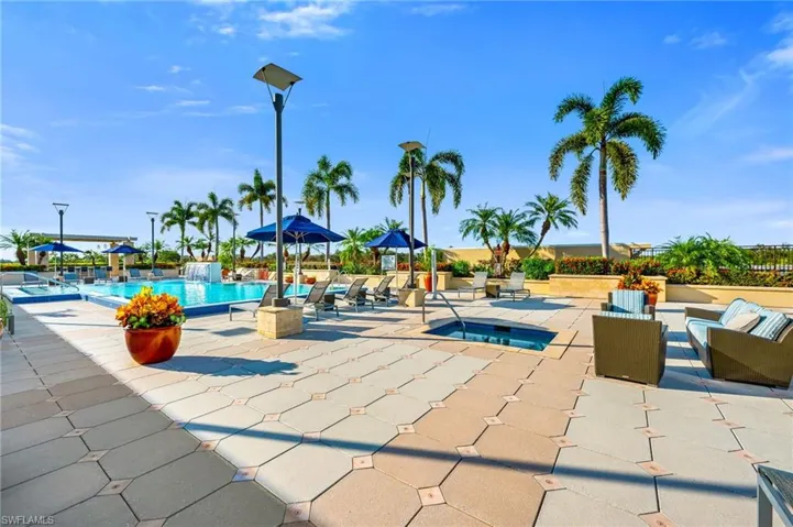 Vibrant roof top pool deck with a swimming pool and a hot tup plus out door lounging area