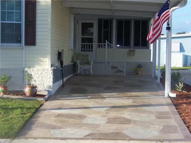 Stamped driveway with nice stairway entry. Custom skirting.