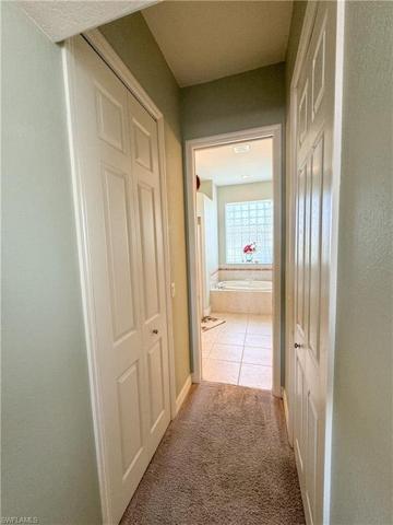 hall to master bath with two closets