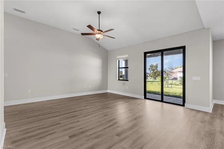 Kitchen featuring gray cabinets, appliances with stainless steel finishes, wood finish floors, and recessed lighting