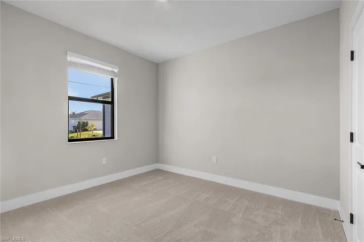Empty room with wood finish floors and ceiling fan