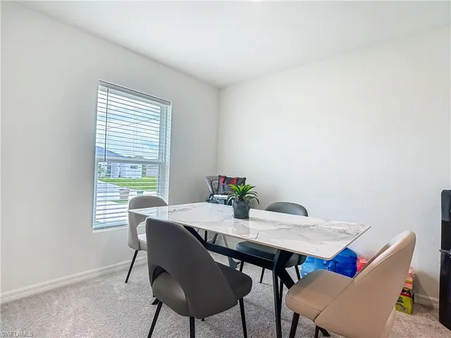 Dining area featuring light carpet