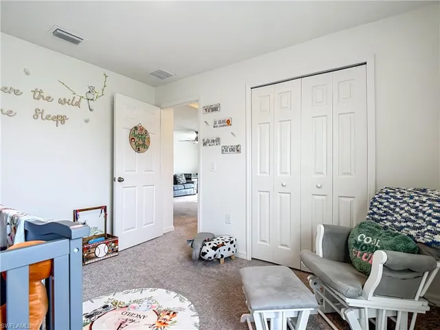 Carpeted bedroom featuring a closet