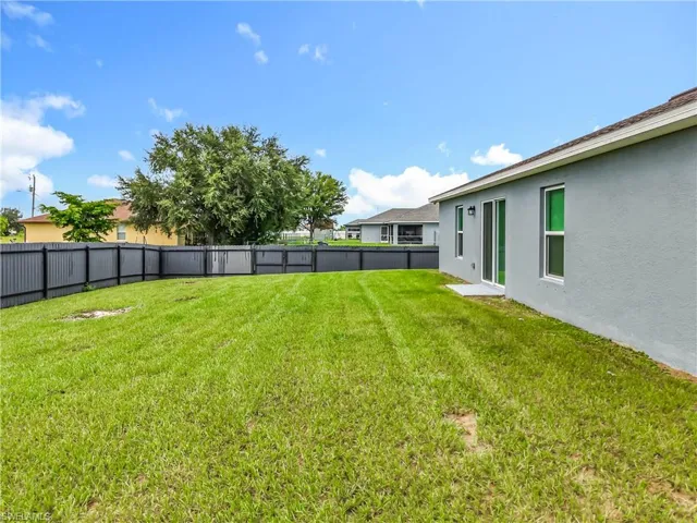 Fenced backyard featuring a patio
