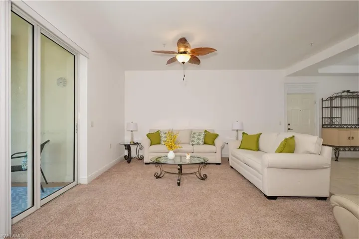 Living room with ceiling fan and carpet floors