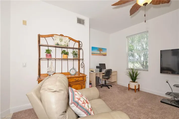 Living room with ceiling fan and carpet floors