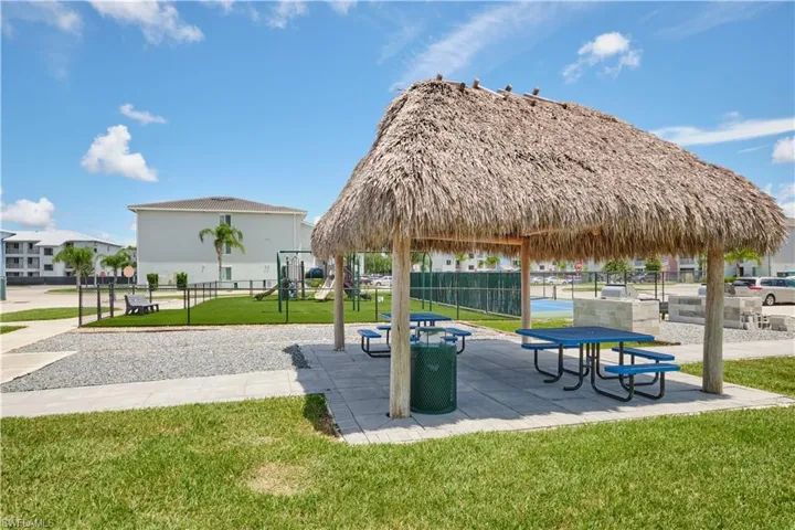 View of nearby features featuring a playground and a lawn