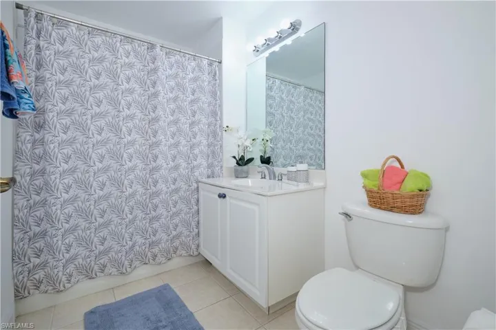 Bathroom featuring tile flooring, vanity, and toilet