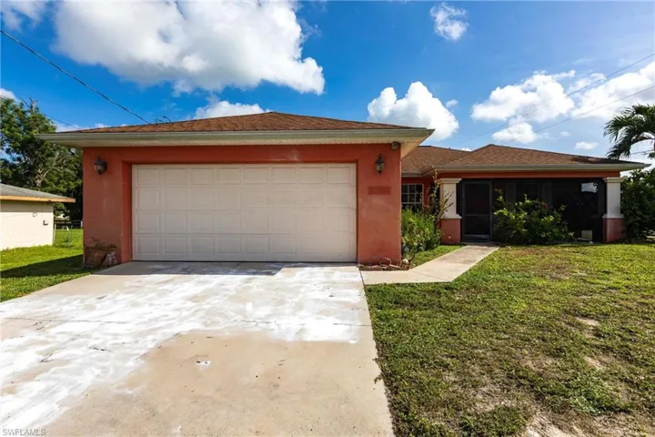 Single story home featuring concrete driveway, a front lawn, stucco siding, an attached garage, and a sunroom