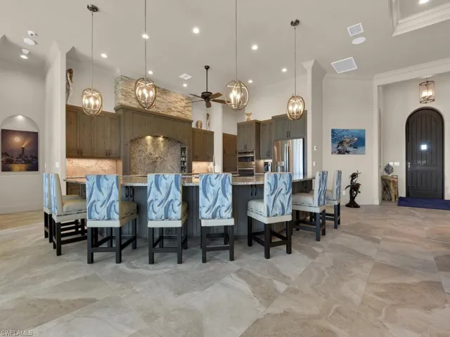 Expansive kitchen island featuring a light-toned countertop and built-in cabinetry