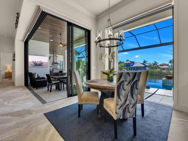 Travertine-style flooring complemented by a contemporary chandelier