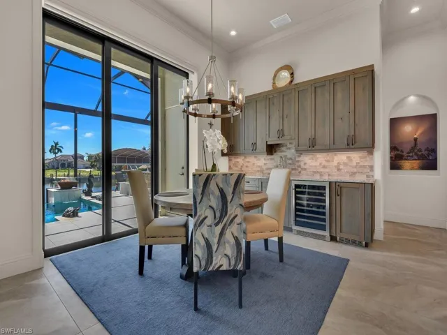 Sliding glass doors opening to an exterior pool and waterway