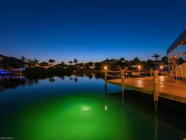 Private wooden dock with rope railings and integrated lighting