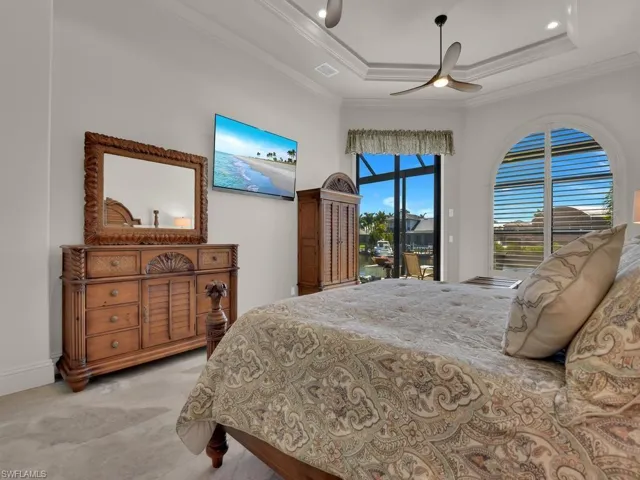 Bedroom featuring a tray ceiling, recessed lighting, and a modern ceiling fan